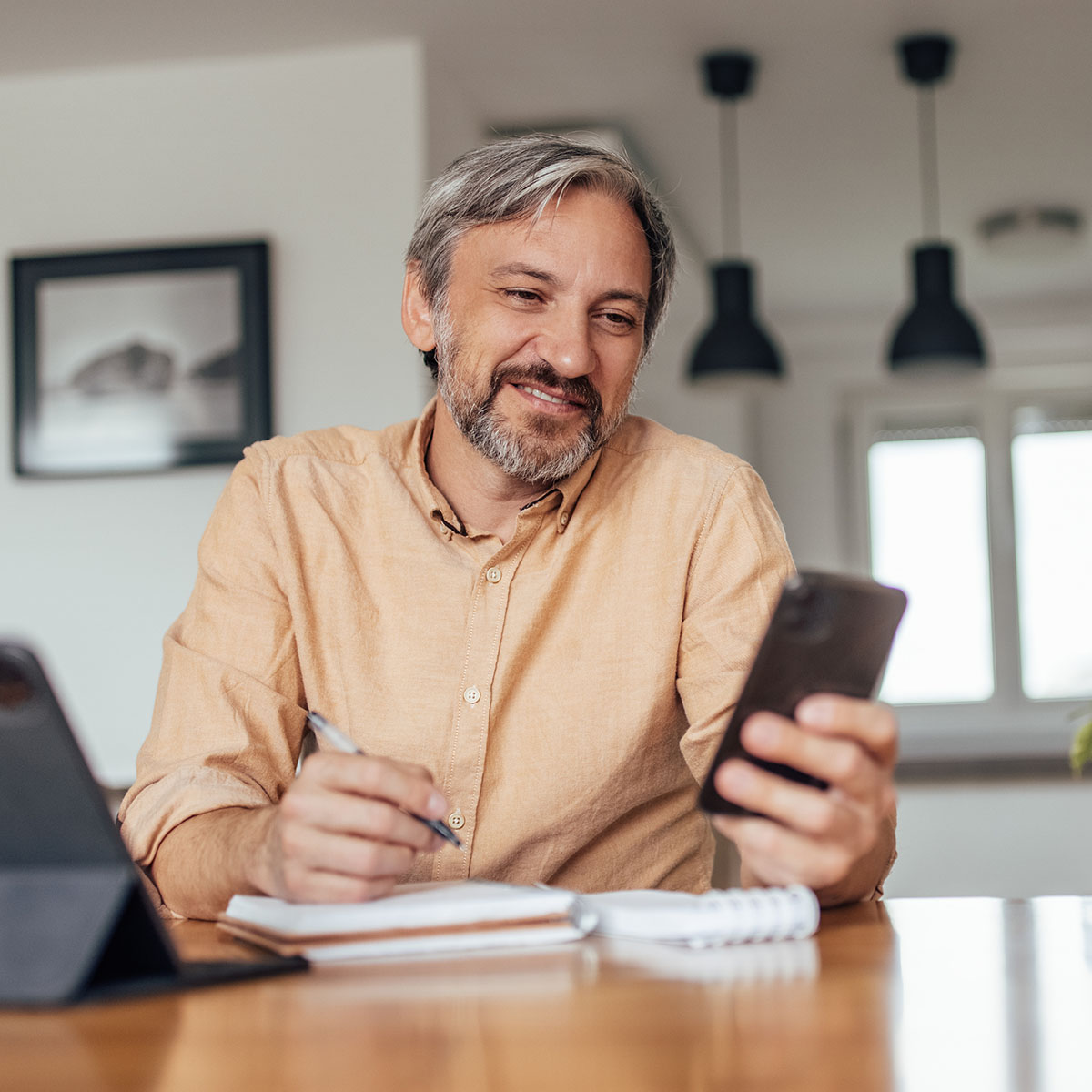 homeowner-mobile-checking-account-access Homeowner reviewing checking account on mobile device