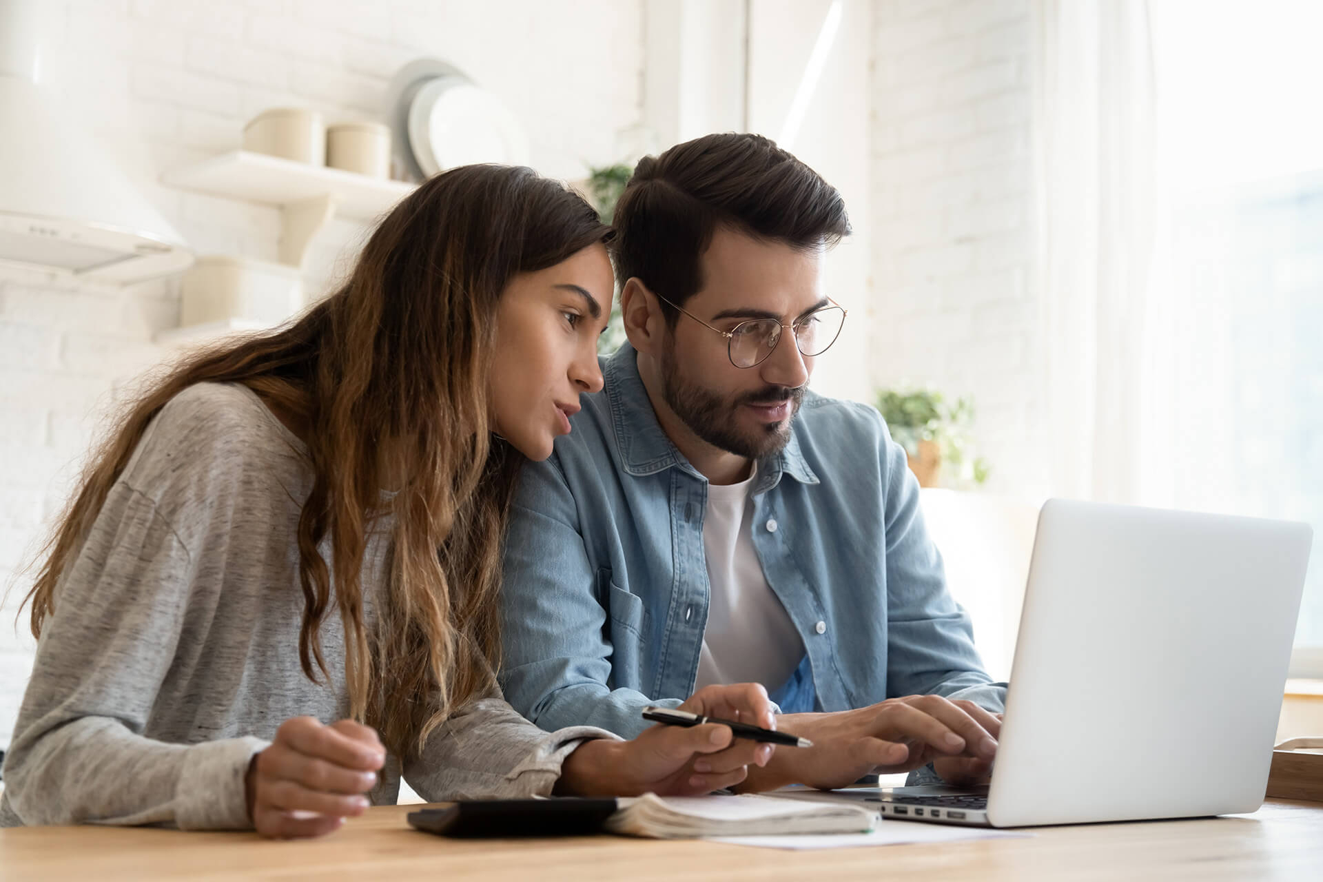 Couple reviewing finances on laptop Happy Couple